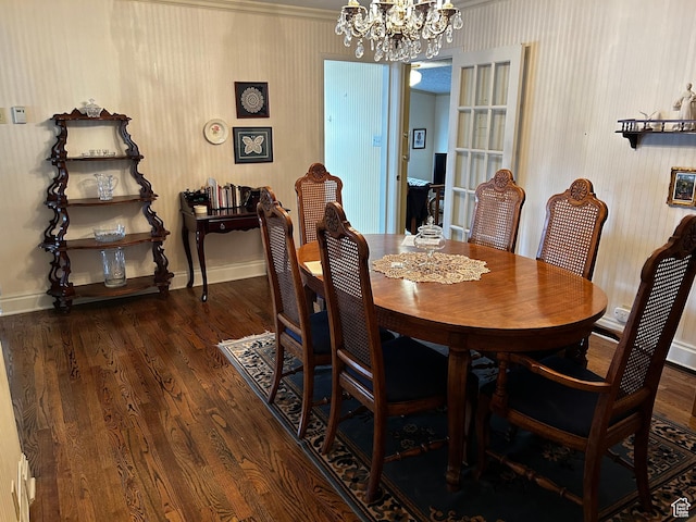dining area featuring baseboards, an inviting chandelier, wood finished floors, and wallpapered walls