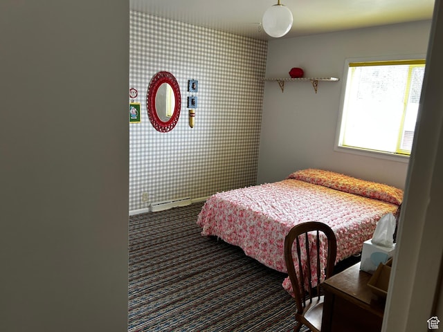 carpeted bedroom with a baseboard radiator, an accent wall, and wallpapered walls