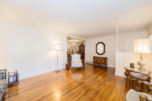 2536 N 575 E, North Ogden, UT 84414 - living area featuring wood finished floors, a chandelier, ornamental molding, and baseboards