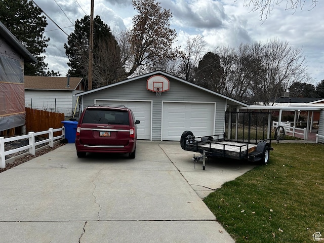 detached garage featuring fence