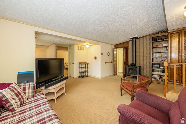2536 N 575 E, North Ogden, UT 84414 - living room featuring a textured ceiling, lofted ceiling, a wood stove, light carpet, and baseboards