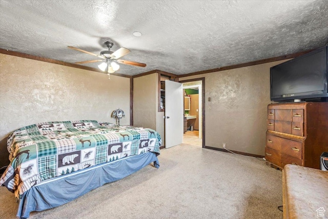 carpeted bedroom featuring ceiling fan, ornamental molding, a textured wall, and a textured ceiling