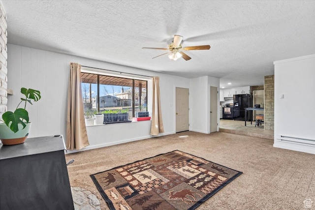 carpeted foyer featuring a textured ceiling, ceiling fan, and baseboards