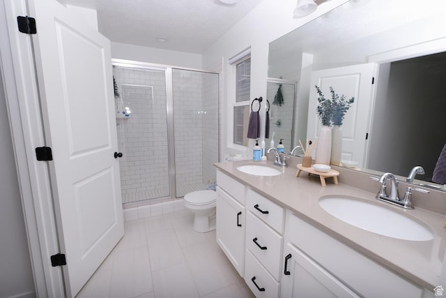 6219 W S Jordan Pkwy Unit 221, South Jordan, UT 84009 - bathroom featuring a shower stall, double vanity, tile patterned floors, and a sink