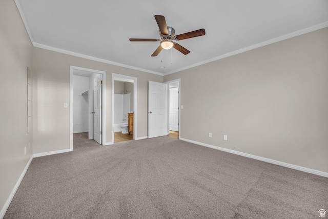 3860 S Mccall St Unit 2D, South Salt Lake, UT 84115 - unfurnished bedroom featuring carpet floors, a walk in closet, crown molding, and baseboards