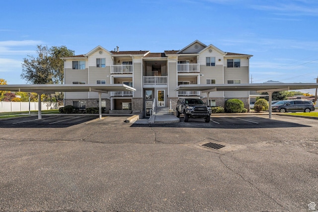 3860 S Mccall St Unit 2D, South Salt Lake, UT 84115 - view of building exterior with covered and uncovered parking