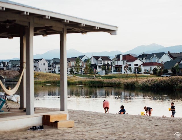 view of water feature with a mountain view and a residential view