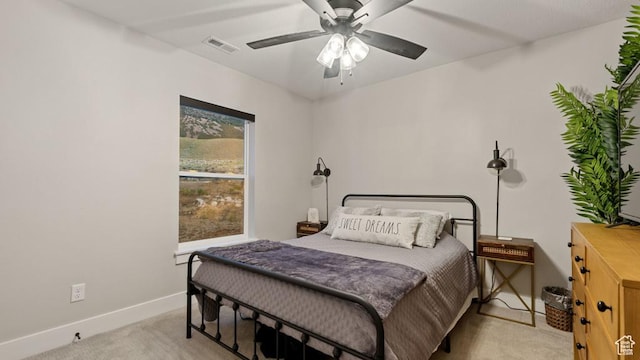 bedroom with baseboards, ceiling fan, visible vents, and light carpet