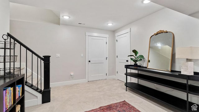 entryway featuring baseboards, carpet floors, stairs, and recessed lighting