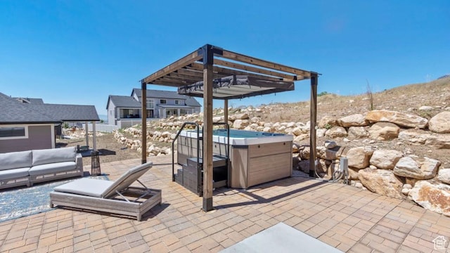 view of patio / terrace with a pergola and a hot tub