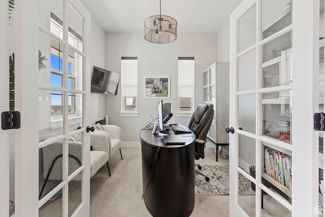 office space with french doors, light carpet, baseboards, and a notable chandelier