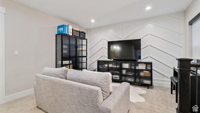 carpeted living area with baseboards and recessed lighting