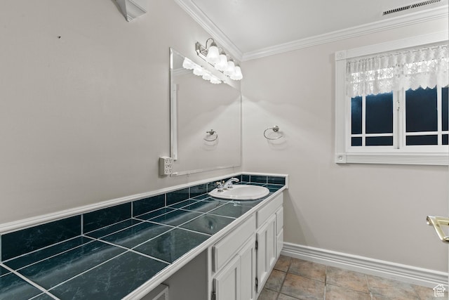 bathroom with baseboards, visible vents, ornamental molding, and vanity
