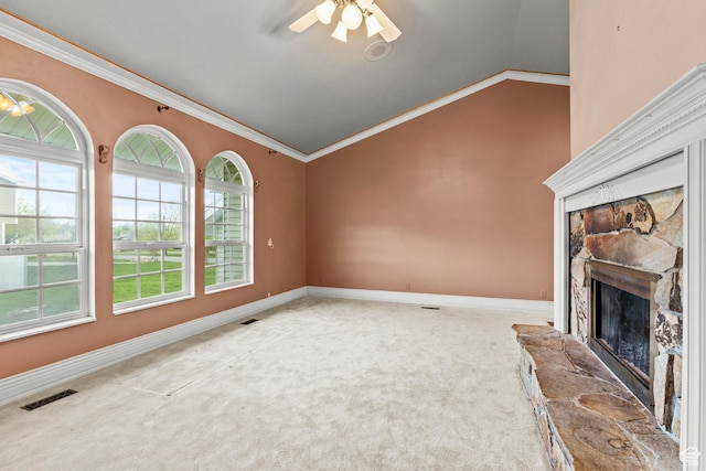 unfurnished living room featuring crown molding, a fireplace, carpet floors, lofted ceiling, and visible vents