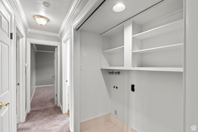 washroom featuring laundry area, crown molding, baseboards, hookup for a washing machine, and light colored carpet