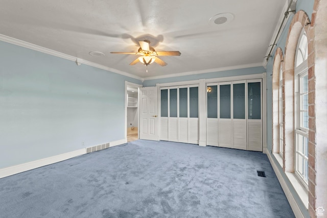 unfurnished room featuring visible vents, ornamental molding, and ceiling fan