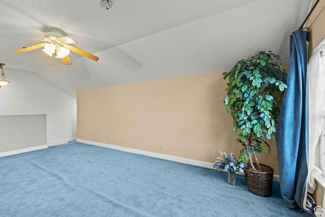 additional living space with carpet floors, baseboards, ceiling fan, and vaulted ceiling