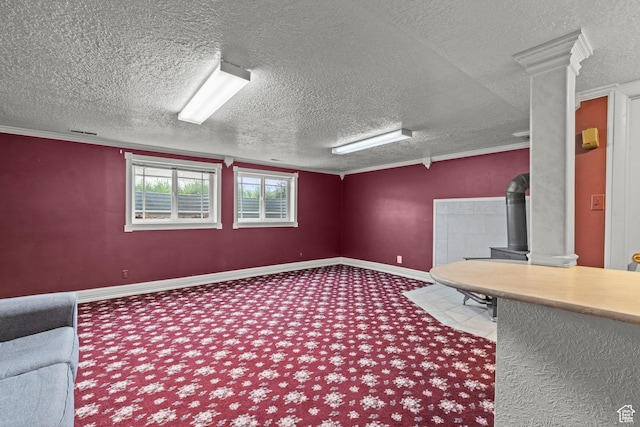 unfurnished office featuring carpet flooring, a textured ceiling, and decorative columns