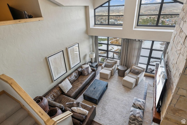 3855 Grand Summit Dr Unit 701Q3, Park City, UT 84098 - living room with a textured wall, a high ceiling, and plenty of natural light