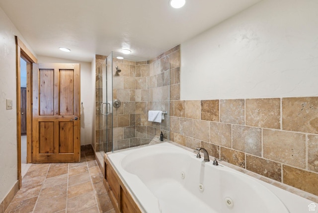 3855 Grand Summit Dr Unit 701Q3, Park City, UT 84098 - bathroom featuring stone tile flooring, a whirlpool tub, a stall shower, and recessed lighting