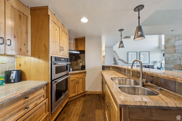 3855 Grand Summit Dr Unit 701Q3, Park City, UT 84098 - kitchen with stainless steel double oven, dark wood-type flooring, backsplash, hanging light fixtures, and a sink