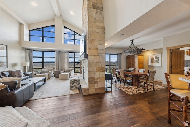 3855 Grand Summit Dr Unit 701Q3, Park City, UT 84098 - living area featuring a stone fireplace, beamed ceiling, high vaulted ceiling, and hardwood / wood-style floors
