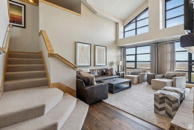 3855 Grand Summit Dr Unit 701Q3, Park City, UT 84098 - living room featuring a high ceiling, dark wood-style floors, baseboards, and stairs