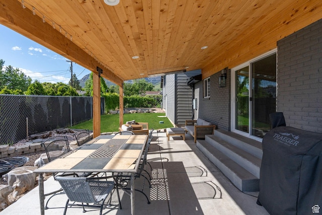 view of patio / terrace featuring a fenced backyard, grilling area, entry steps, and outdoor dining area