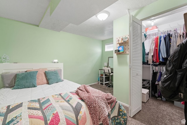 bedroom featuring a closet, a textured ceiling, baseboards, and carpet