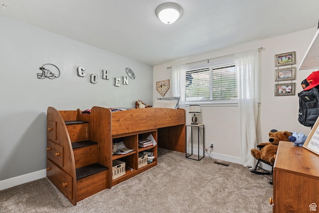bedroom with baseboards, carpet floors, and visible vents