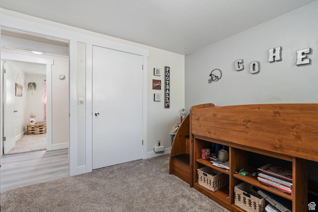 carpeted bedroom featuring baseboards