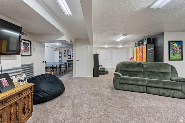 living area with carpet flooring, a textured ceiling, and visible vents