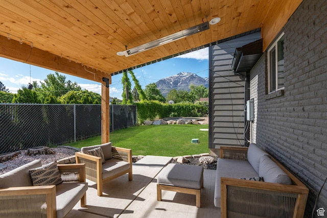 view of patio / terrace with a fenced backyard, an outdoor hangout area, a mountain view, and entry steps