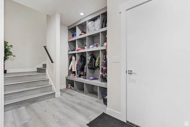 mudroom with recessed lighting, baseboards, and wood finished floors