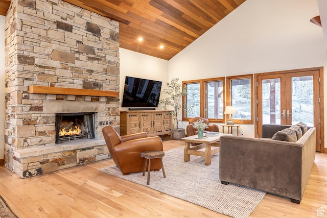 living room featuring high vaulted ceiling, a fireplace, wood finished floors, french doors, and wooden ceiling
