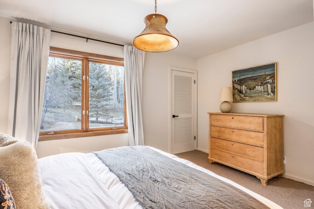 bedroom featuring light carpet and baseboards