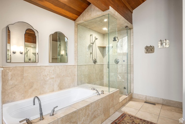 bathroom featuring a stall shower, tile patterned flooring, a bath, baseboards, and visible vents