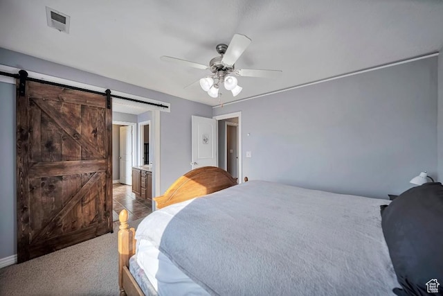 1951 N Hollow Ct, Lehi, UT 84043 - carpeted bedroom featuring ensuite bath, a barn door, ceiling fan, and visible vents