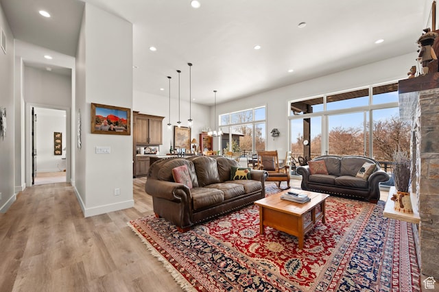 481 Thorn View Ct Unit 6, Kamas, UT 84036 - living room featuring baseboards, light wood-style flooring, a towering ceiling, and recessed lighting