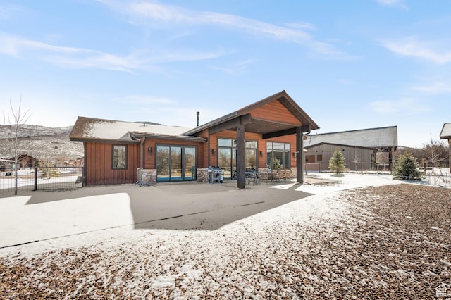481 Thorn View Ct Unit 6, Kamas, UT 84036 - back of house with stone siding, fence, a mountain view, and a patio area