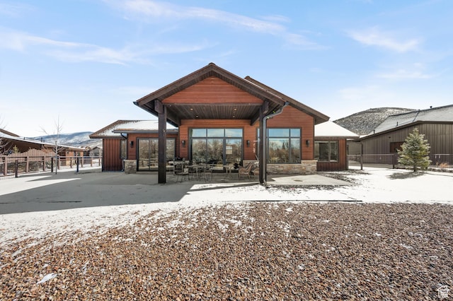 481 Thorn View Ct Unit 6, Kamas, UT 84036 - snow covered house featuring a patio area, fence, stone siding, and a mountain view