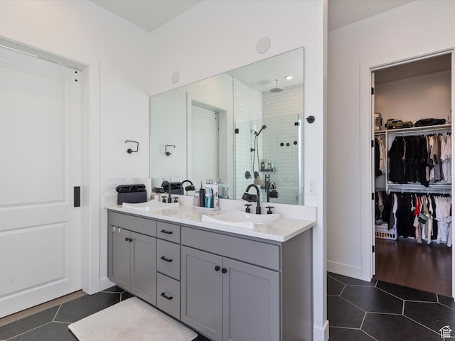 full bath featuring tile patterned floors, a sink, and a stall shower