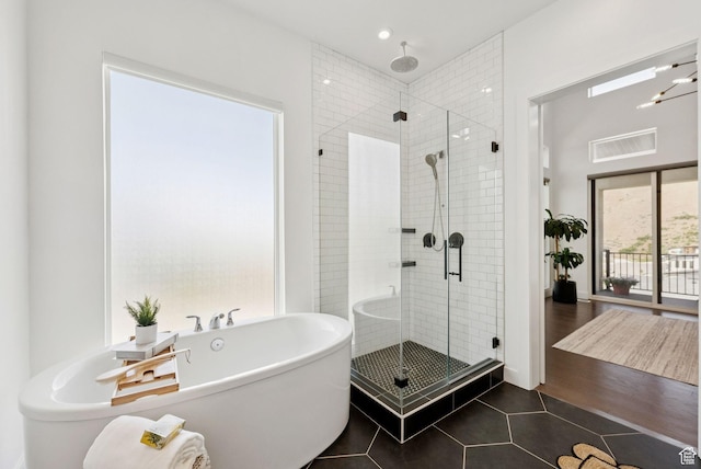 5641 N Canyon Rim Rd, Lehi, UT 84043 - bathroom featuring a shower stall, a freestanding tub, tile patterned flooring, and recessed lighting