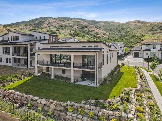 5641 N Canyon Rim Rd, Lehi, UT 84043 - rear view of property with stucco siding, a balcony, and a mountain view