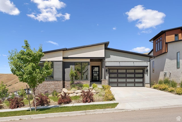 5641 N Canyon Rim Rd, Lehi, UT 84043 - contemporary house featuring stone siding, a garage, and driveway