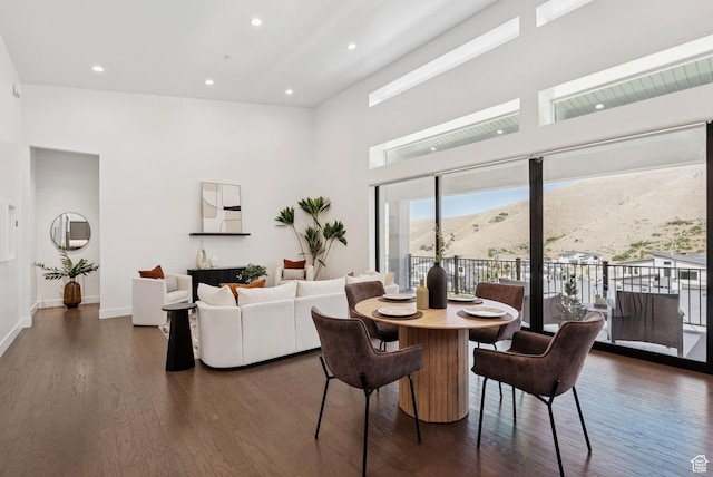 5641 N Canyon Rim Rd, Lehi, UT 84043 - dining area featuring a towering ceiling, dark wood-style floors, baseboards, a mountain view, and recessed lighting