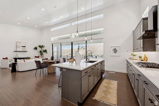5641 N Canyon Rim Rd, Lehi, UT 84043 - kitchen with a sink, gray cabinetry, appliances with stainless steel finishes, wall chimney range hood, and a towering ceiling