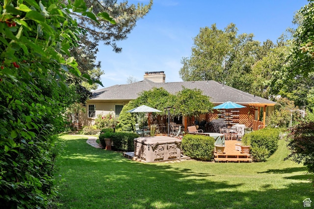 1376 Granada Dr, Bountiful, UT 84010 - rear view of property featuring a yard, a deck, a shingled roof, and a chimney