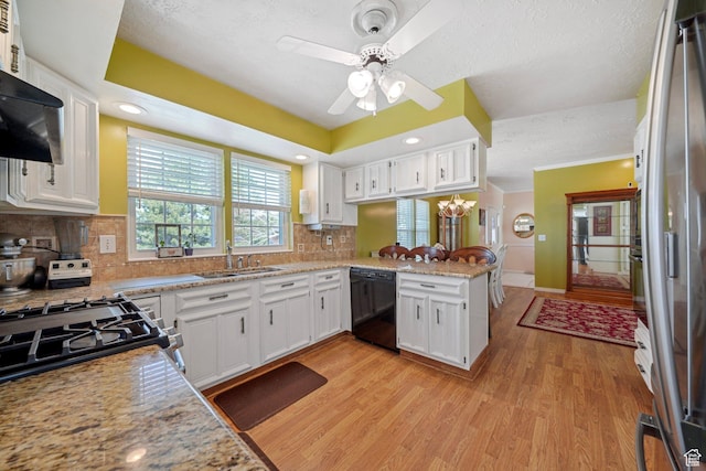 1376 Granada Dr, Bountiful, UT 84010 - kitchen with a peninsula, appliances with stainless steel finishes, white cabinetry, a sink, and light wood-type flooring