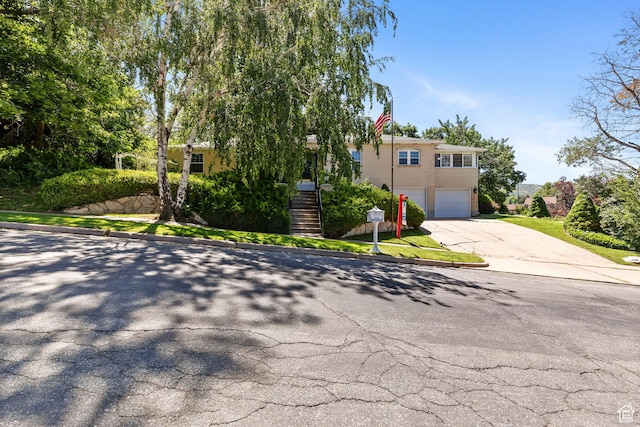 1376 Granada Dr, Bountiful, UT 84010 - view of front of property with driveway, an attached garage, and stairs